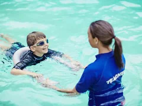 a person and a boy in the water