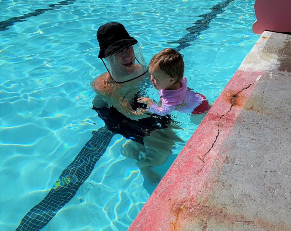 a person and a child in a pool