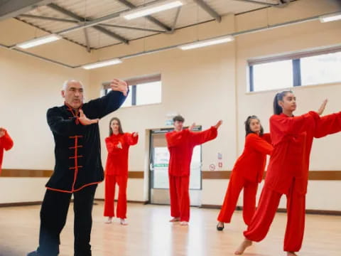 a group of people in red jumpsuits in a room