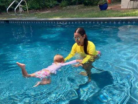 a person and a baby in a pool