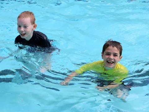 a couple of boys in a pool