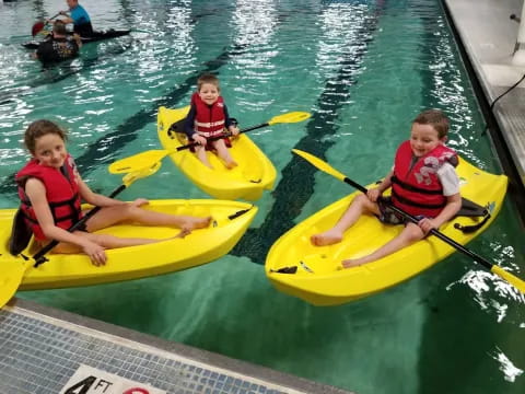 a group of boys in kayaks