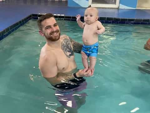 a person and a baby in a pool