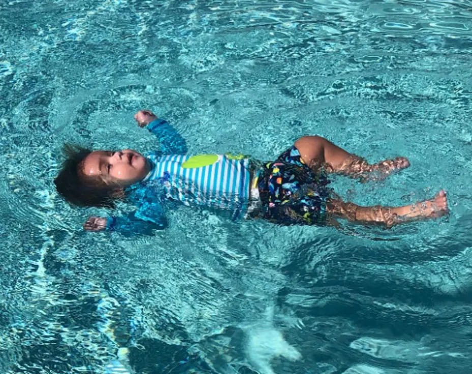 a boy swimming in water