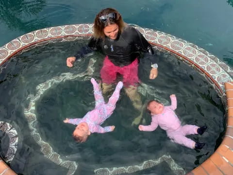 a person and two children in a pool