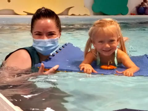 a person and a child in a pool