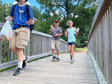 a group of people running on a wooden bridge