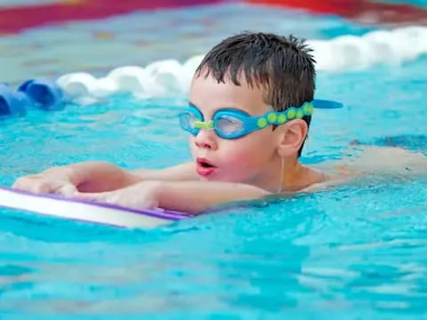 a baby swimming in a pool