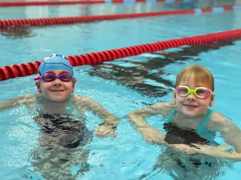 a couple of kids in a pool