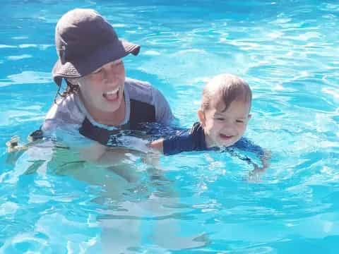 a person and a baby in a pool