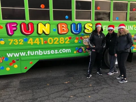 a group of people posing for a photo in front of a bus