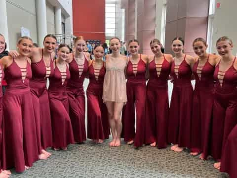 a group of women in red dresses