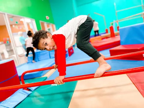 a boy doing a plank on a mat