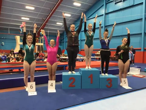 a group of women posing on a podium