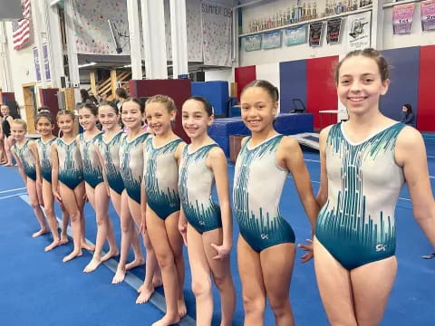 a group of girls in swimsuits in a pool