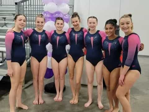 a group of women in swimsuits posing for a photo