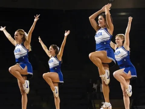 a group of cheerleaders jumping in the air