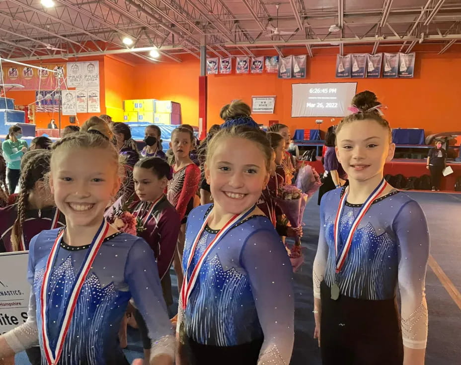 a group of girls wearing medals