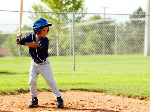 a young boy playing baseball