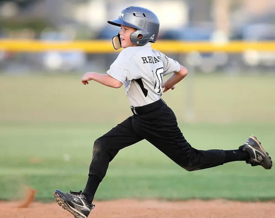 a young boy running on a field