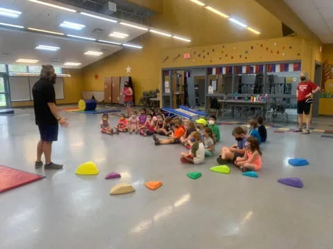 a group of children playing in a gym