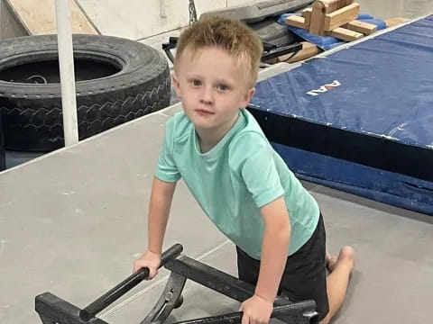 a boy sitting on a tire