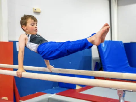 a boy doing a handstand on a bar