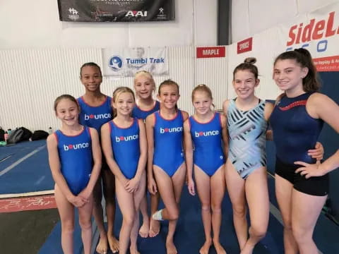 a group of women in swimsuits posing for a photo