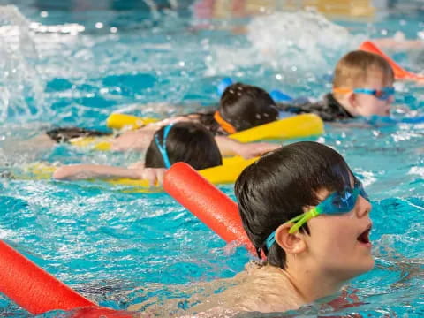 a group of kids in a pool