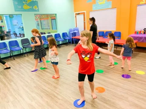 a group of children playing with frisbees