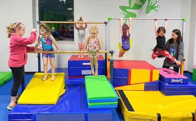 a group of children playing on mats