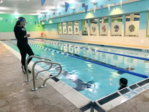 a person jumping into a swimming pool