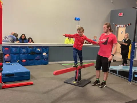 a couple of people stand on skateboards