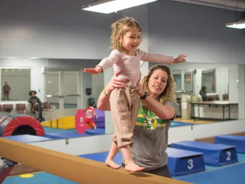 a person holding a child on a trampoline