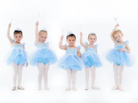 a group of girls in blue dresses