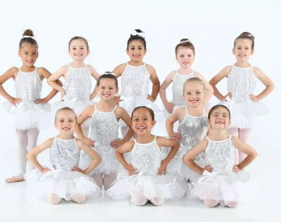 a group of girls in white dresses