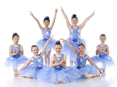 a group of women in blue dresses