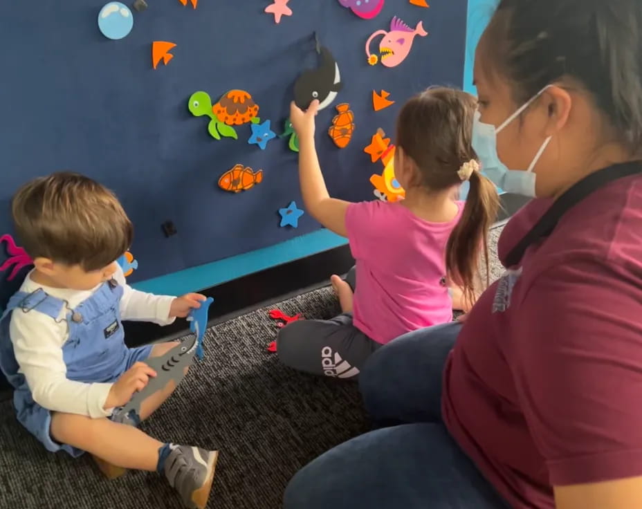 a person and several children sitting on the floor