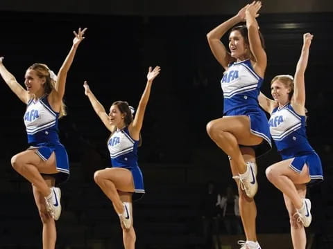 a group of cheerleaders jumping in the air