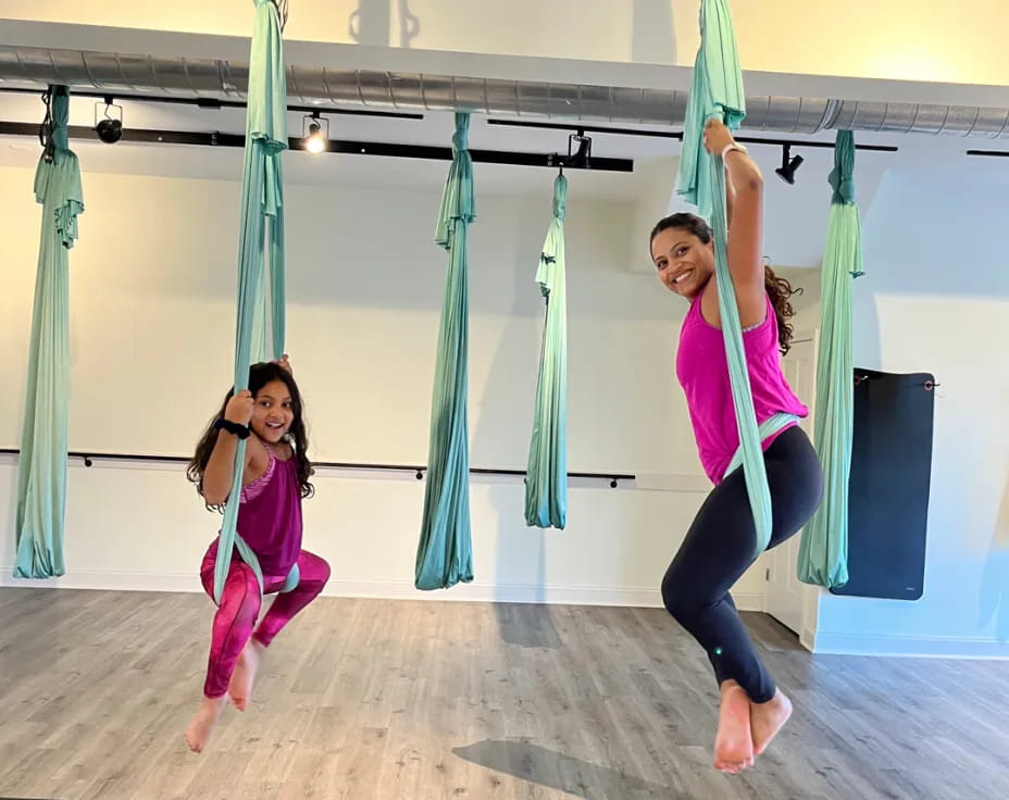 a couple of girls from a rope in a gym