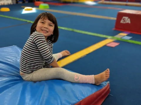 a child lying on a mat