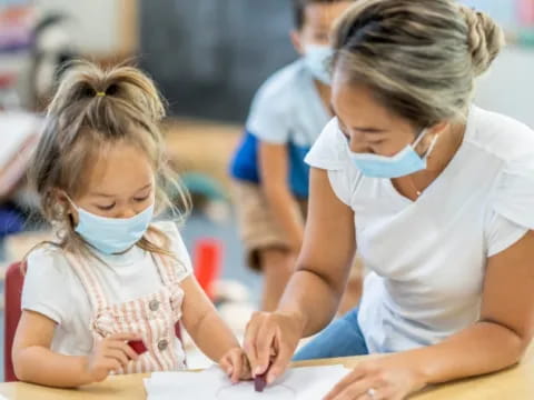 a person and a girl looking at a paper