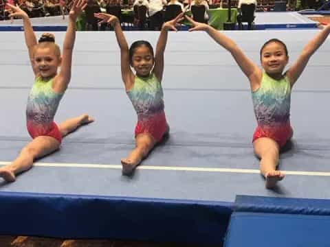 a group of girls jumping in a gym