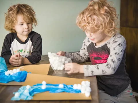 a couple of kids playing with a cake