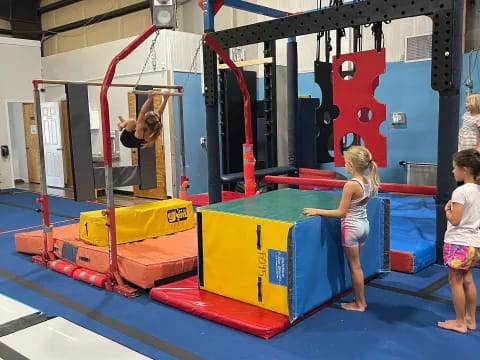 a girl and a boy playing on a trampoline