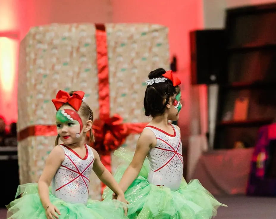 a couple of girls wearing dresses and dancing