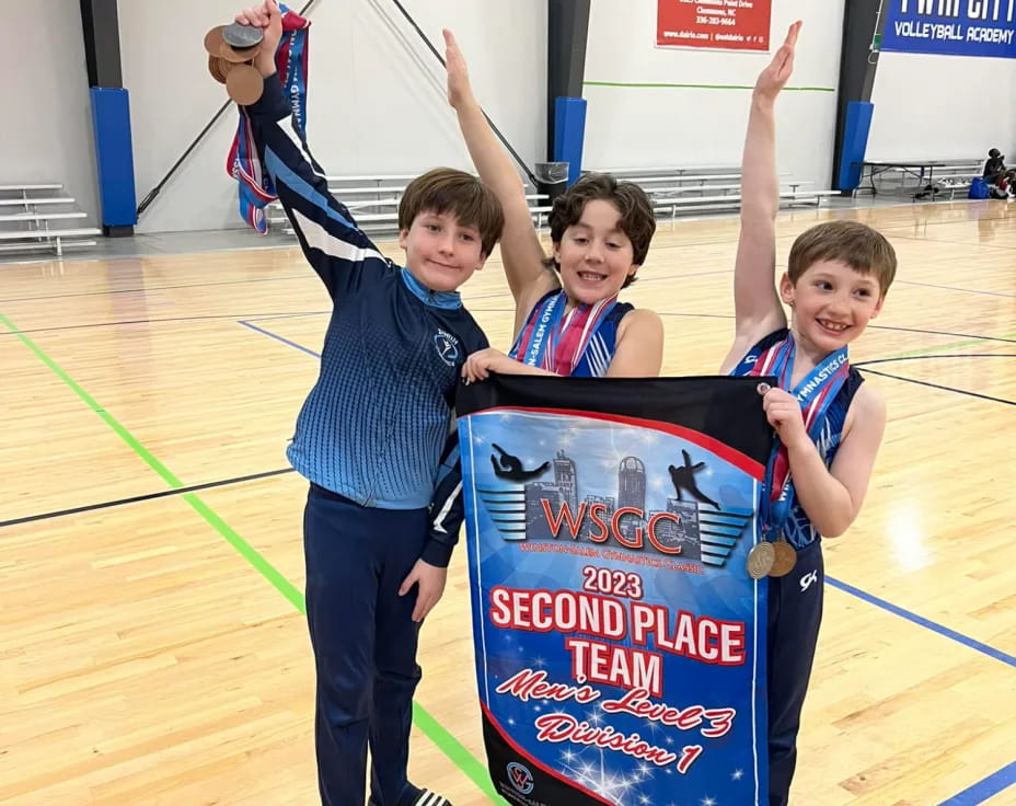 a group of boys holding up a sign