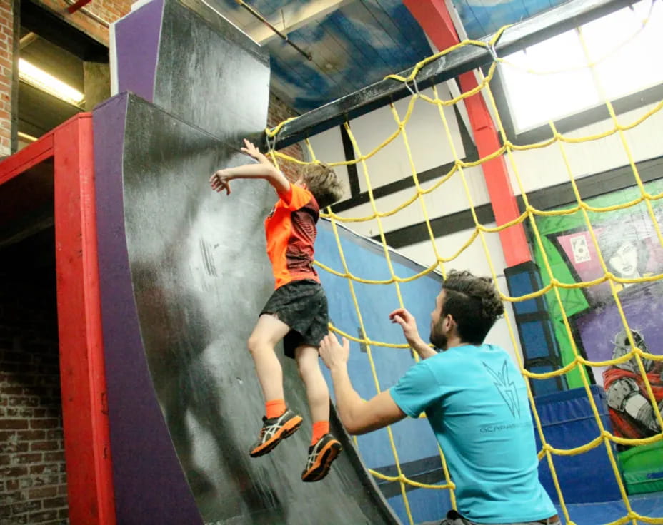 a man and a woman climbing a wall