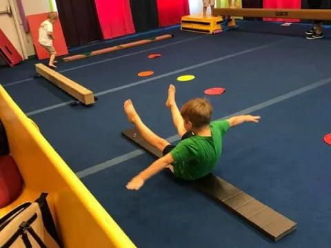 a boy sitting on a mat