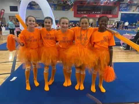 a group of people wearing orange jumpsuits posing for the camera